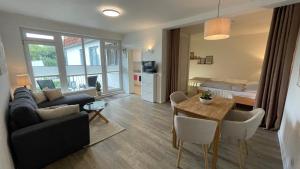 a living room with a couch and a table at Schönes Appartement in Neubrandenburg