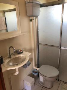 a small bathroom with a sink and a toilet at Casa em Torres Ao Lado da Praia da Guarita in Torres