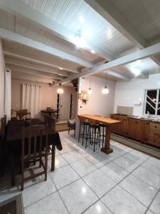 a dining room and kitchen with a table and chairs at Refúgio Beija flor in Alfredo Wagner +16 photos