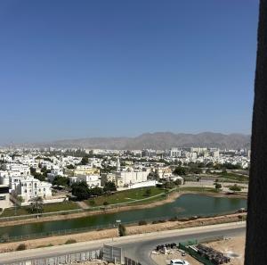 a view of a city with a river and buildings at Sea and lake view apartment in Muscat