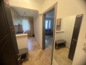 a view of a room with a mirror and a hallway at Ywa in Râmnicu Vâlcea +33 photos
