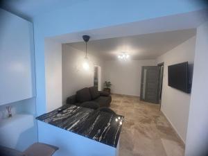 a living room with a couch and a table at Ywa in Râmnicu Vâlcea