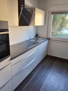 a kitchen with a sink and a window at Ferienwohnung in Weil am Rhein