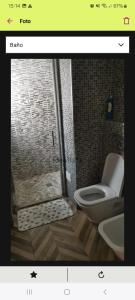 a bathroom with a shower with a toilet and a sink at FC house in Valencia
