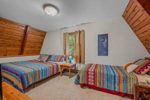 a bedroom with two beds and a window at Cozy - Experience It All in Berkeley Springs +28 photos