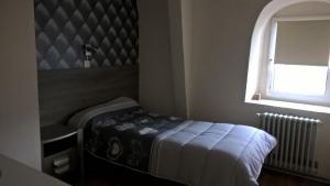 a small bedroom with a bed and a window at Annapolis in Aix-les-Bains +9 photos