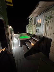 an outdoor deck with a pool table and a pool table at Le Cocoon SPA du MAIDO in Le Guillaume +6 photos
