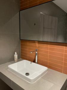 a white sink on a counter in a bathroom at Samui 2 Bedroom Apartment - Near Beach & Night Market in Ban Lamai