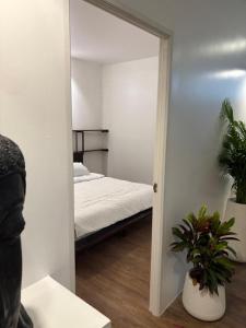 a bedroom with a mirror and a bed in it at Samui 2 Bedroom Apartment - Near Beach & Night Market in Ban Lamai