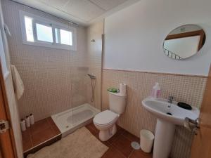 a bathroom with a toilet and a shower and a sink at Hidden Gem between Waves & Mountains in Lo Gea +13 photos