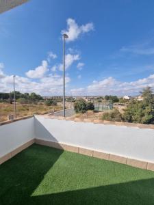 a balcony with green grass and a street light at Hidden Gem between Waves & Mountains in Lo Gea