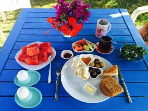 a blue table with plates of food on it at Maviev Otel in Çeşme