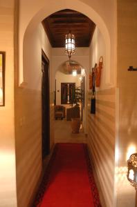 a hallway with a red carpet and an archway at Riad Aubrac in Marrakech