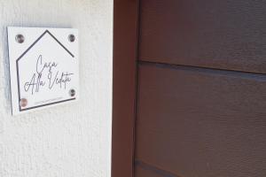 a door with a sign that says over the door at Casa Alla Veduta in Trento