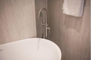 a bathroom with a toilet with a faucet at Kosnian Villa with Jeep Renegade Hybrid in Zipárion +20 photos