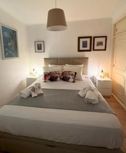 a bedroom with a large bed with towels on it at Ribeiro house in Lourinhã +24 photos