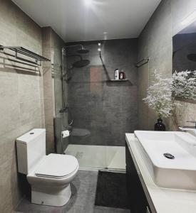 a bathroom with a toilet and a sink and a shower at Ribeiro house in Lourinhã +28 photos