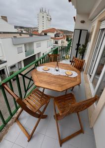 a table and chairs on a balcony with a view at Ribeiro house in Lourinhã