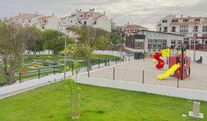 a playground with a slide in a park at Ribeiro house in Lourinhã