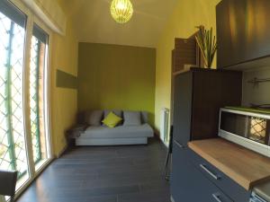 a living room with a couch and a window at RoMare, tra Roma e il Mare in Acilia