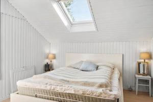 a white bedroom with a bed with a skylight at OH514-Hadsund-Ryttermarken-37 in Hadsund