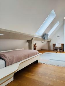 a attic bedroom with a bed and a piano at Exklusives Penthouse im ehemaligen Bunker in Hannover