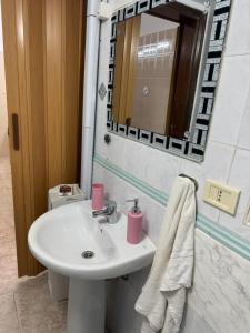 a bathroom with a sink and a mirror at Da nonno filuccio in San Severo +16 photos