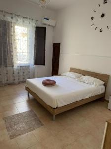 a bed in a bedroom with a clock on the wall at Da nonno filuccio in San Severo