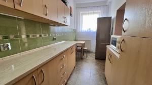 a kitchen with a refrigerator and a table in it at Apartament pod Góralką in Polanica-Zdrój