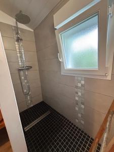 a bathroom with a shower with a window at Chambre indépendante au pied de la Rhune in Urrugne
