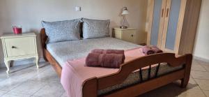 a bedroom with a bed with a dog laying on it at FarmHouse near Airport in Paianía