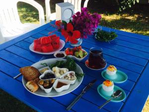a blue table with plates of food on it at Maviev Otel in Çeşme +44 photos