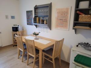 a dining room with a table and chairs with flowers on it at Ferienwohnung Am Meisenberg in Marsberg