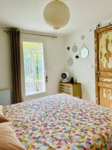 a bedroom with a large bed and a window at Le Jardin in LʼIsle-sur-la-Sorgue +22 photos