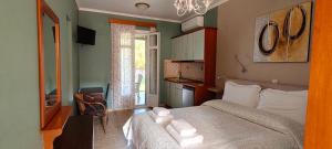 a bedroom with a bed with towels on it at Edem Studios in Syvota