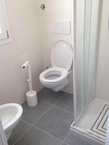 a bathroom with a toilet and a sink at appartamento giorgia in Schio +3 photos