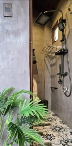 a bathroom with a shower with a plant at Casa Elia San Juan La Union in San Juan +23 photos