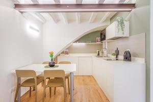 una cucina e una sala da pranzo con tavolo e sedie di Corso Adriano 13 - I Giardini a Modena Altre 15 foto