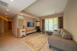 a living room with a couch and a tv at Melekona House in Kartepe