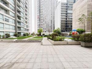 a courtyard in a city with tall buildings at SantiagoCentral in Santiago
