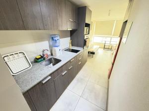 a kitchen with a sink and a counter top at SantiagoCentral in Santiago +4 photos