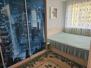 a bedroom with a view of a city through a window at Gerassimovi 16 in Narva