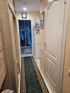 a hallway with a door and a clock on the wall at Gerassimovi 16 in Narva