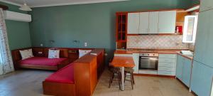 a kitchen with a couch and a table in a room at Edem Studios in Syvota