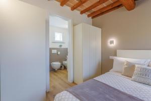 Ένα ή περισσότερα κρεβάτια σε δωμάτιο στο Corso Adriano 13 - I Portici