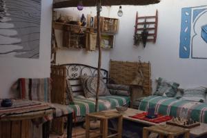 a living room with a couch and a table at Bright Wave Surfhouse in Tamraght Ouzdar +71 photos