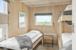 a bedroom with two beds and a window at G608-Lemvig-Gyvelvej-8 in Lemvig