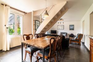 a dining room with a wooden table and chairs at Maison lumineuse à 50m de la mer idéale en famille in Riantec +46 photos