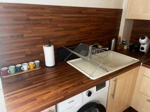a kitchen counter with a dish drying rack and a washing machine at La Maison de Julie in Cagnes-sur-Mer +5 photos