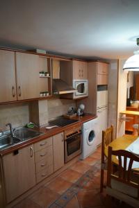 a kitchen with a sink and a stove top oven at Alojamiento la Morada de la Luz in Úbeda